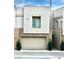 Modern home exterior with a two-car garage and decorative stone accents at 600 N Carriage Hill Dr # 1082, Las Vegas, NV 89138