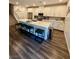 Modern kitchen features white cabinets, stainless steel appliances, and a large center island with seating at 600 N Carriage Hill Dr # 1082, Las Vegas, NV 89138