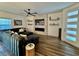 Living room with decorative fireplace, TV, floating shelves, and light-filled front door at 600 N Carriage Hill Dr # 1082, Las Vegas, NV 89138