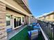 Cozy outdoor patio featuring modern wicker furniture and stylish lighting with a view of the neighborhood at 600 N Carriage Hill Dr # 1082, Las Vegas, NV 89138