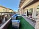Cozy outdoor patio with artificial grass, stone columns, and stylish seating at 600 N Carriage Hill Dr # 1082, Las Vegas, NV 89138