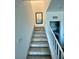 Carpeted staircase leads to laundry area with updated appliances, natural light, and neutral decor at 600 N Carriage Hill Dr # 1082, Las Vegas, NV 89138