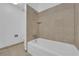 Bathroom tub and shower with neutral-toned tile, creating a spa-like ambiance at 6299 W Washington Ave, Las Vegas, NV 89107