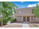 Inviting townhome featuring mature trees, secure windows, and individual front door access at 6299 W Washington Ave, Las Vegas, NV 89107