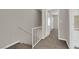 Upstairs hallway provides access to several rooms, with carpeted floors and neutral walls at 6299 W Washington Ave, Las Vegas, NV 89107