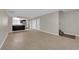 Open-concept living space with tile floors, stairs and a view into the kitchen area at 6299 W Washington Ave, Las Vegas, NV 89107