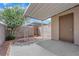 Private outdoor patio area with a mature flowering tree creating a serene retreat at 6299 W Washington Ave, Las Vegas, NV 89107