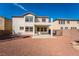 Backyard exterior view of a two-story house with a patio and ample space at 7098 Seabirds Pl, North Las Vegas, NV 89084