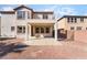 Home's backyard with gravel, a covered patio, and a second-story balcony above at 7098 Seabirds Pl, North Las Vegas, NV 89084