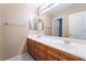 Bathroom featuring a dual sink vanity with wood cabinetry and a large mirror at 7098 Seabirds Pl, North Las Vegas, NV 89084