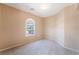 Bedroom with neutral carpet and paint featuring a window at 7098 Seabirds Pl, North Las Vegas, NV 89084