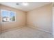 Bright bedroom with a window offering neighborhood views and neutral-toned walls and carpeting at 7098 Seabirds Pl, North Las Vegas, NV 89084