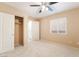 This cozy bedroom features a ceiling fan, closet, neutral carpet and fresh paint at 7098 Seabirds Pl, North Las Vegas, NV 89084