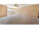Upstairs bonus room with neutral carpet, multiple windows and ceiling fan at 7098 Seabirds Pl, North Las Vegas, NV 89084