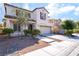 Charming home with well-maintained landscaping, a two-car garage, and a welcoming entrance at 7098 Seabirds Pl, North Las Vegas, NV 89084