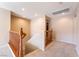 Hallway featuring wood railing, neutral paint and carpet, and recessed lighting at 7098 Seabirds Pl, North Las Vegas, NV 89084