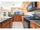Kitchen boasts granite countertops, stainless steel appliances, and well-lit tile flooring at 7098 Seabirds Pl, North Las Vegas, NV 89084