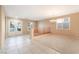 Bright living room with tile flooring, plush carpeting and a decorative glass entry door at 7098 Seabirds Pl, North Las Vegas, NV 89084