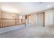 Open concept living room area with plush carpet, tile entry way and warm neutral paint at 7098 Seabirds Pl, North Las Vegas, NV 89084