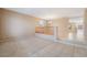 Open living room featuring neutral carpeting, railing, and tile entry at 7098 Seabirds Pl, North Las Vegas, NV 89084