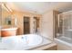 Bright main bathroom features soaking tub, tiled shower, and dual vanities at 7098 Seabirds Pl, North Las Vegas, NV 89084