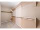 Carpeted walk-in closet featuring shelving and ample storage space at 7098 Seabirds Pl, North Las Vegas, NV 89084