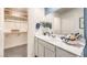 Bathroom with a white vanity and a large mirror, adjacent to a walk-in closet at 7384 Hayes Harbor Ct # Lot 213, North Las Vegas, NV 89084