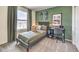 Bedroom with green walls, natural light, and decorative skateboards at 7384 Hayes Harbor Ct # Lot 213, North Las Vegas, NV 89084