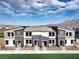 Stylish townhome showcasing neat front yards, modern architecture, and mountain views at 7384 Hayes Harbor Ct # Lot 213, North Las Vegas, NV 89084