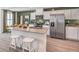 Well-equipped kitchen featuring stainless steel appliances, sleek countertops, and island with breakfast bar at 7384 Hayes Harbor Ct # Lot 213, North Las Vegas, NV 89084