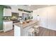 Modern kitchen boasting white cabinets, stainless steel appliances, and a kitchen island with seating at 7384 Hayes Harbor Ct # Lot 213, North Las Vegas, NV 89084