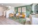 Comfortable living room featuring stylish decor, green accent wall, and lots of natural light at 7384 Hayes Harbor Ct # Lot 213, North Las Vegas, NV 89084