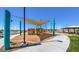 Bright community playground area with covered seating, walking path, and shade structures at 7384 Hayes Harbor Ct # Lot 213, North Las Vegas, NV 89084