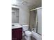 Bathroom featuring a vanity, toilet, and shower-tub combo with sliding doors at 805 Rock Springs Dr # 101, Las Vegas, NV 89128
