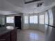 Dining Area with tile flooring and large windows, complemented by the stainless steel refrigerator at 805 Rock Springs Dr # 101, Las Vegas, NV 89128