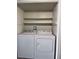 Laundry room featuring a white washer and dryer set with above shelving for storage at 805 Rock Springs Dr # 101, Las Vegas, NV 89128