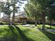Community clubhouse with manicured lawns, lush trees, and steps leading to the entrance at 8139 Retriever Ave, Las Vegas, NV 89147