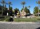 Community entrance showcasing a tiered fountain, landscaped grounds, and mature palm trees at 8139 Retriever Ave, Las Vegas, NV 89147