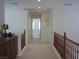 Upstairs hallway with carpet, leading to bedrooms, showcasing natural light and neutral tones at 8139 Retriever Ave, Las Vegas, NV 89147