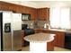 Gourmet kitchen with granite countertops, dark wood cabinetry, and stainless steel appliances at 8139 Retriever Ave, Las Vegas, NV 89147