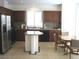 Well-equipped kitchen with stainless steel appliances, dark cabinets, and a breakfast nook at 8139 Retriever Ave, Las Vegas, NV 89147