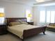 Spacious primary bedroom with bay windows, plantation shutters, and luxurious furnishings at 8139 Retriever Ave, Las Vegas, NV 89147
