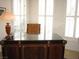 Stylish office with plantation shutters, a luxurious desk, and decorative lamp at 8139 Retriever Ave, Las Vegas, NV 89147