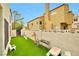 Private backyard with artificial turf, BBQ, playground, and block wall at 8404 Shore Breeze Dr, Las Vegas, NV 89128