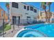 Relaxing backyard featuring a sparkling pool and spa with mature palm trees at 8404 Shore Breeze Dr, Las Vegas, NV 89128
