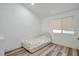 A cozy bedroom with warm-toned wood floors and a natural light-filled window at 8404 Shore Breeze Dr, Las Vegas, NV 89128