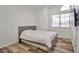 Bedroom with wood flooring and window with blinds and grey headboard at 8404 Shore Breeze Dr, Las Vegas, NV 89128