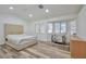 Bright bedroom with wood flooring, large windows, and a crib at 8404 Shore Breeze Dr, Las Vegas, NV 89128