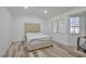 Spacious bedroom features neutral tones, wood flooring, and a window for natural light at 8404 Shore Breeze Dr, Las Vegas, NV 89128