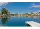 Relaxing lake view featuring a floating dock and surrounding residential homes reflected in the calm water at 8404 Shore Breeze Dr, Las Vegas, NV 89128